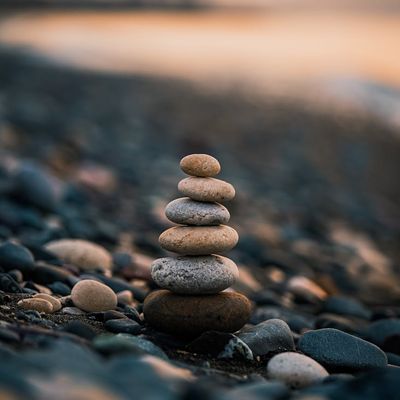 Stack of smooth stones balanced on a beach.